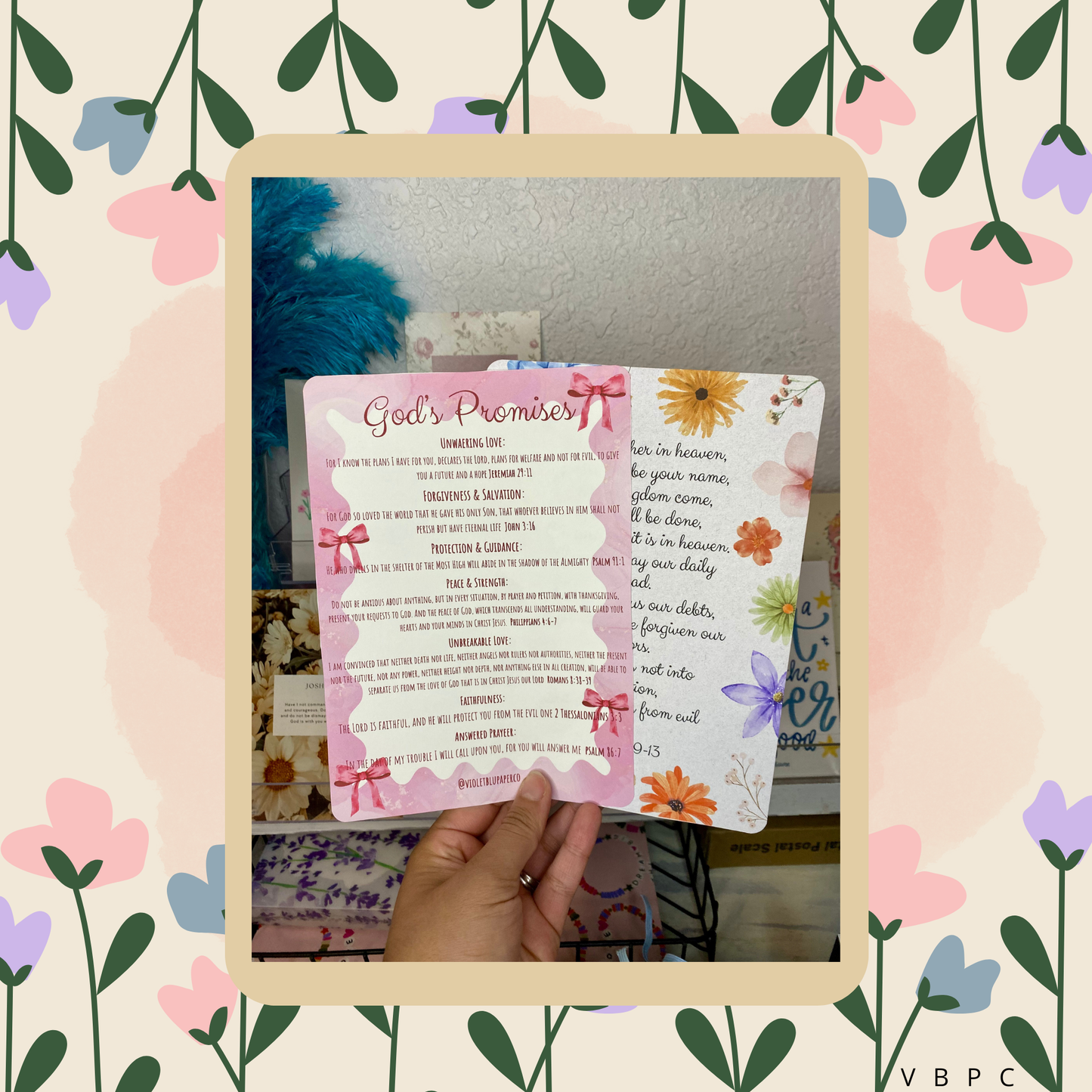 Hand holding a card with 'God's Promise' text against a floral and nature-themed background.
